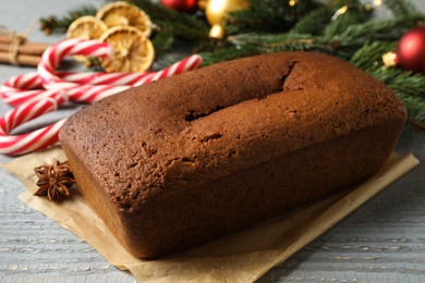 Photo of Delicious gingerbread cake and Christmas items on wooden table