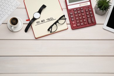 Photo of Flat lay composition with notebook on white wooden table, space for text. Tips and Tricks