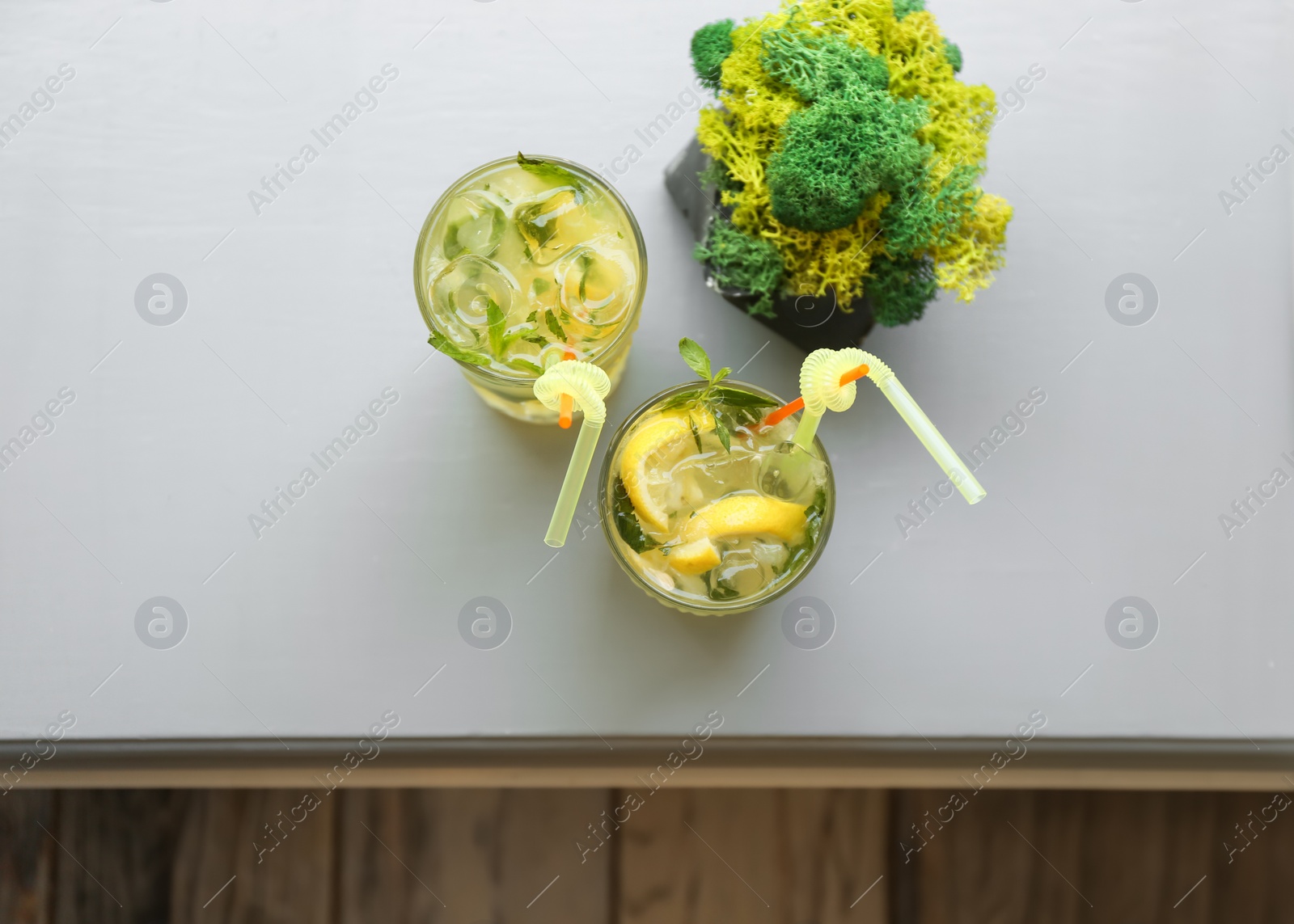 Photo of Glasses of iced lemonade on table, top view