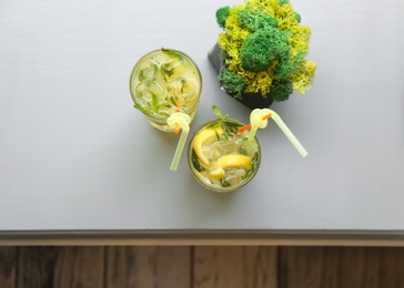 Glasses of iced lemonade on table, top view