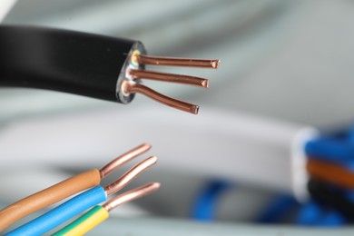 Photo of Colorful electrical wires on blurred background, closeup