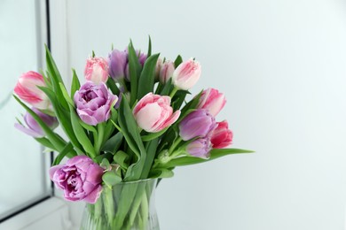 Beautiful bouquet of colorful tulip flowers indoors. Space for text