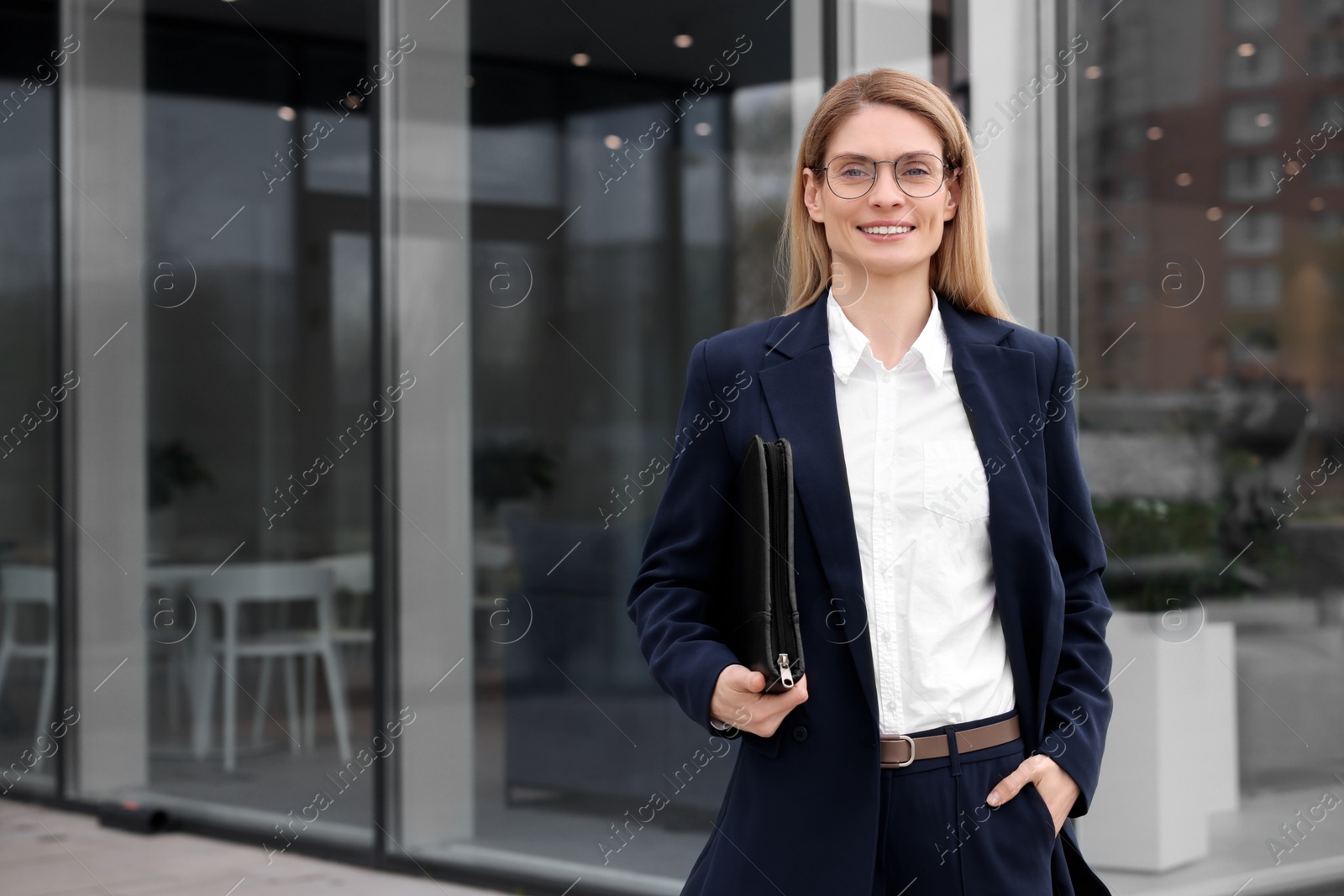 Photo of Real estate agent with leather portfolio outdoors. Space for text