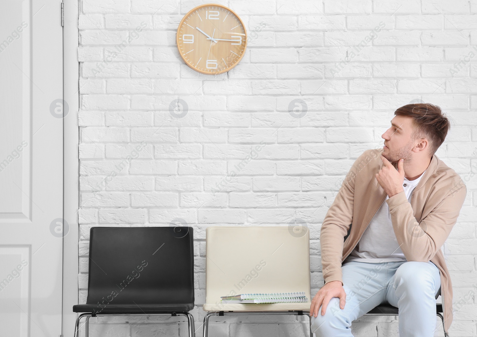 Photo of Young man waiting for job interview, indoors