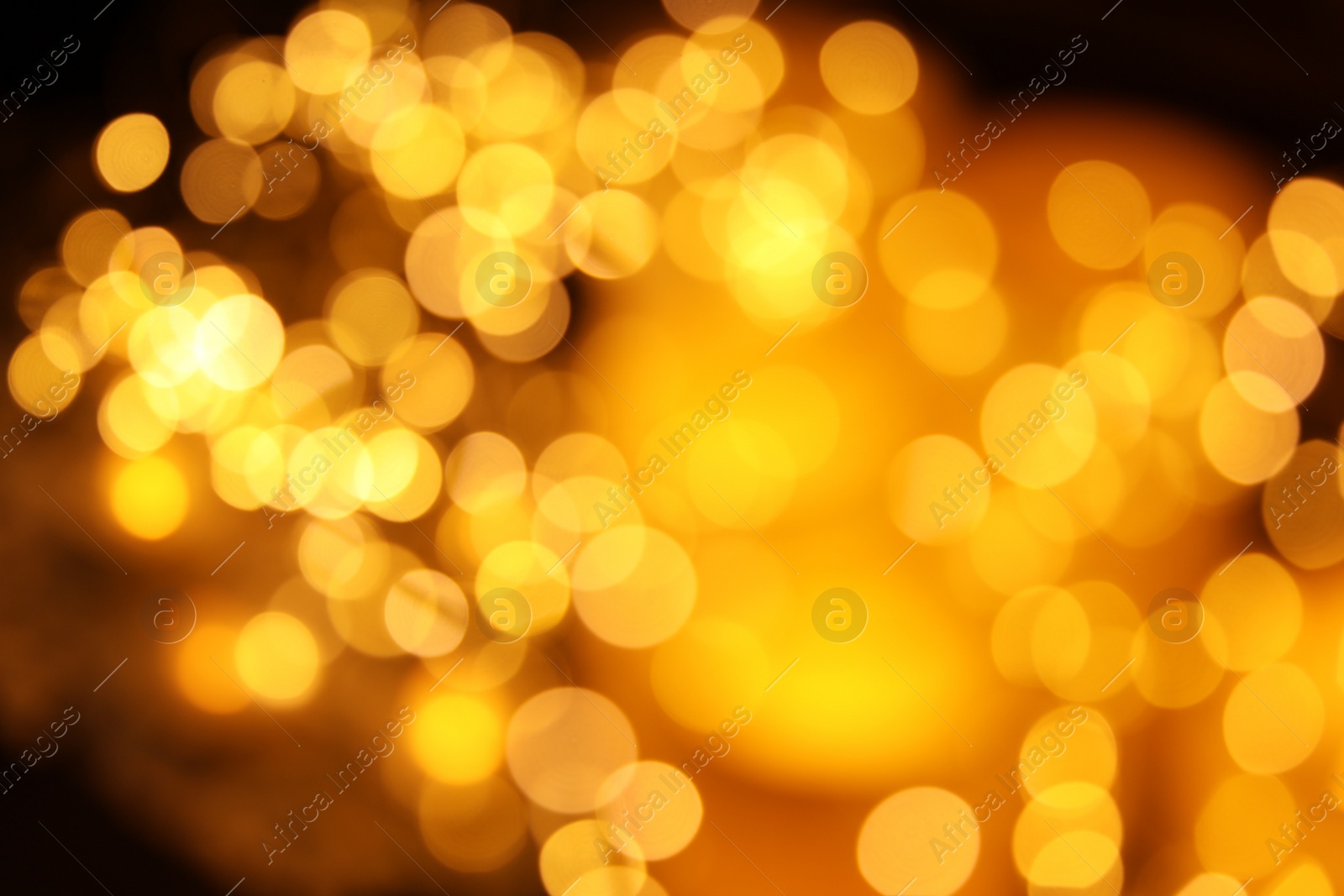 Photo of Gold glitter with bokeh effect on dark background