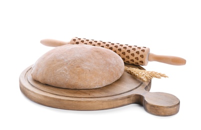 Photo of Wooden board with raw rye dough and rolling pin on white background