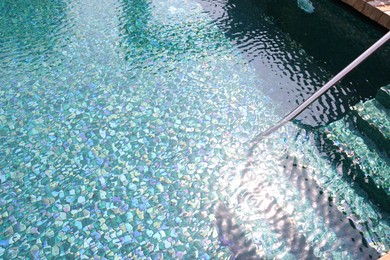 Photo of Outdoor swimming pool with steps and rail at resort