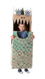 Cute little boy playing with cardboard dragon on white background