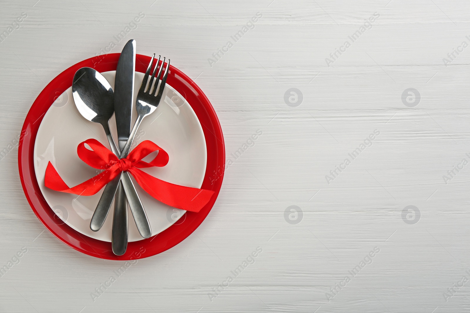 Photo of Beautiful table setting on white wooden background, top view with space for text. Valentine's Day dinner