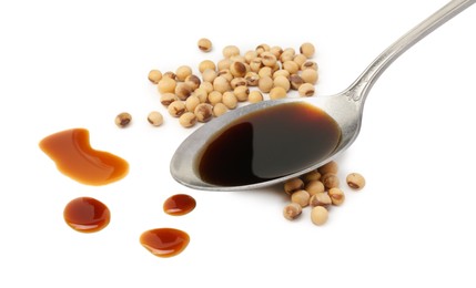 Photo of Tasty soy sauce in spoon and soybeans isolated on white