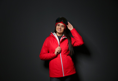 Photo of Woman wearing stylish winter sport clothes on black background