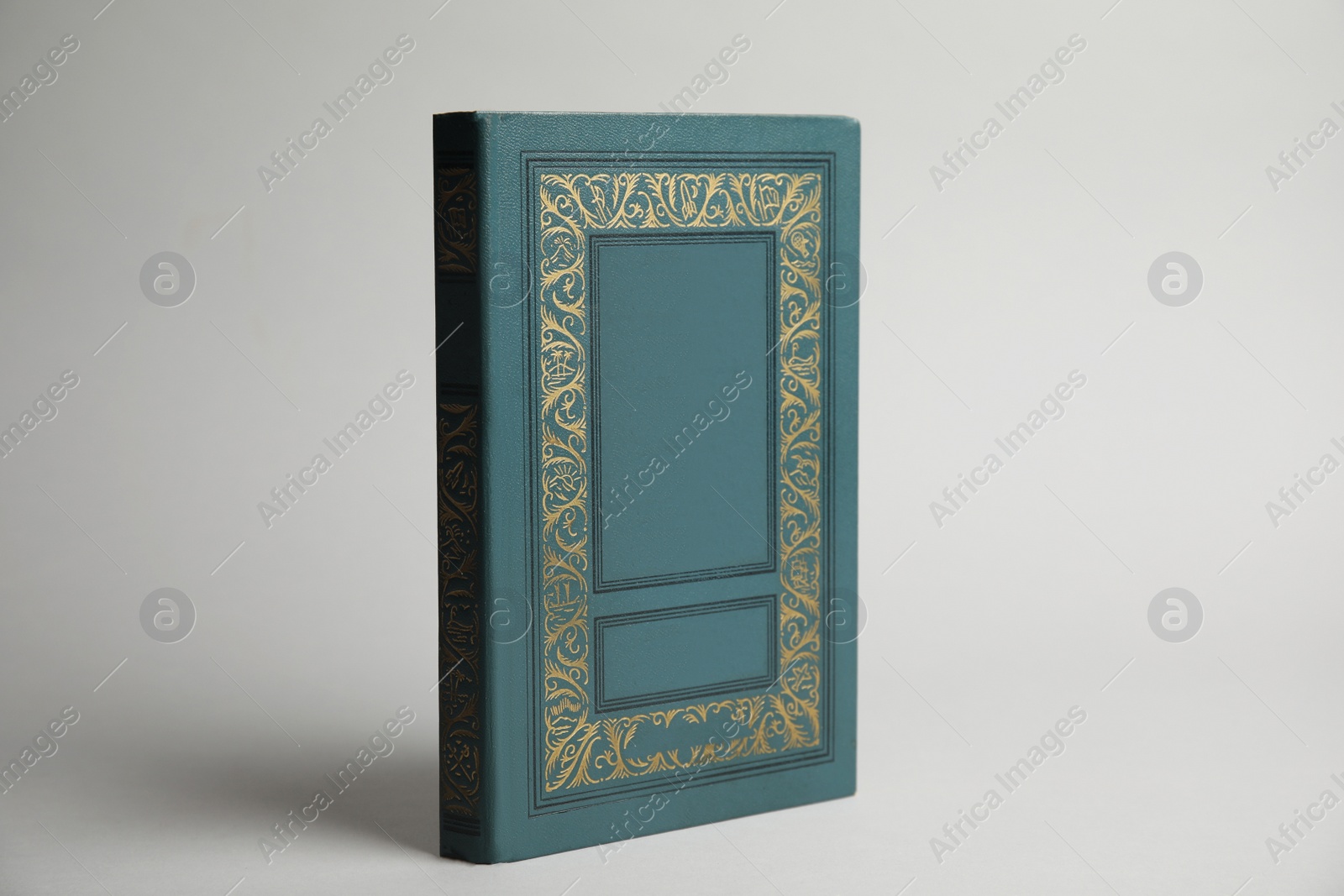 Photo of Hardcover book on light grey background. Space for design