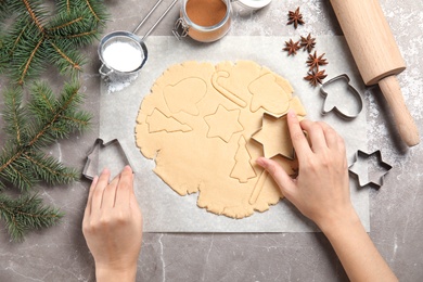 Photo of Young woman preparing Christmas cookies on table, top view