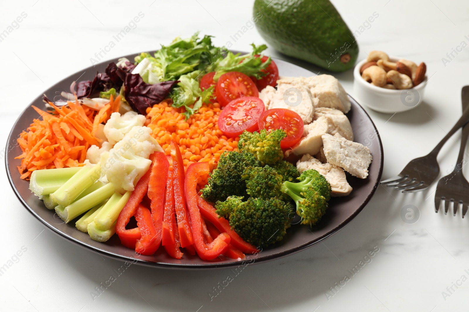 Photo of Balanced diet and healthy foods. Plate with different delicious products on white marble table