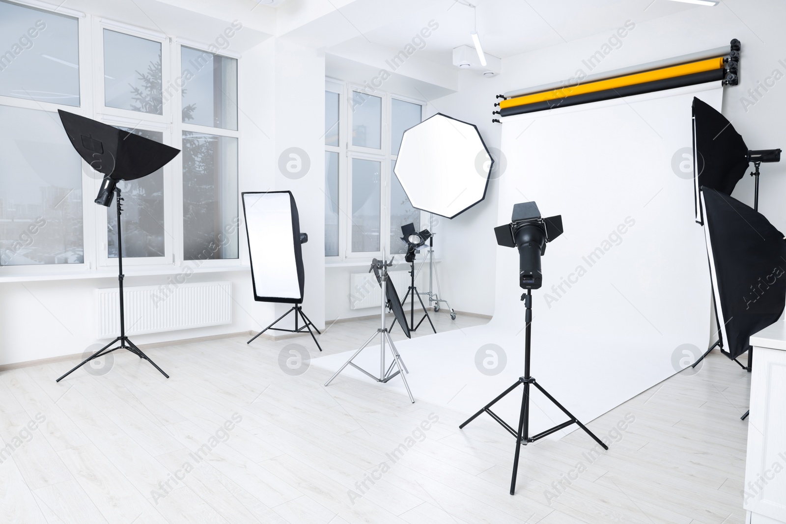 Photo of Interior of modern photo studio with professional lighting equipment