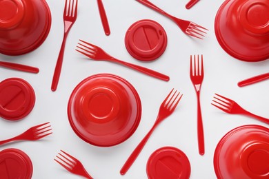 Photo of Plastic dishware on white background, flat lay