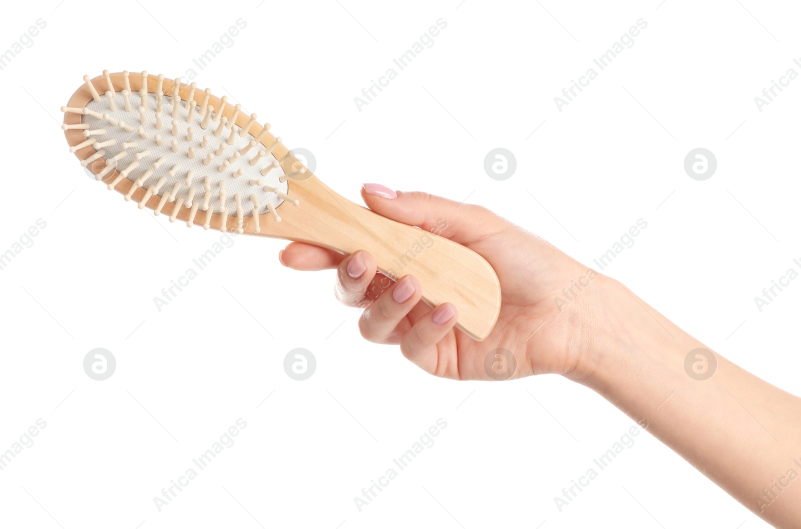 Photo of Woman holding wooden hair brush against white background, closeup