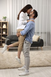 Love relationship. Passionate young couple kissing at home