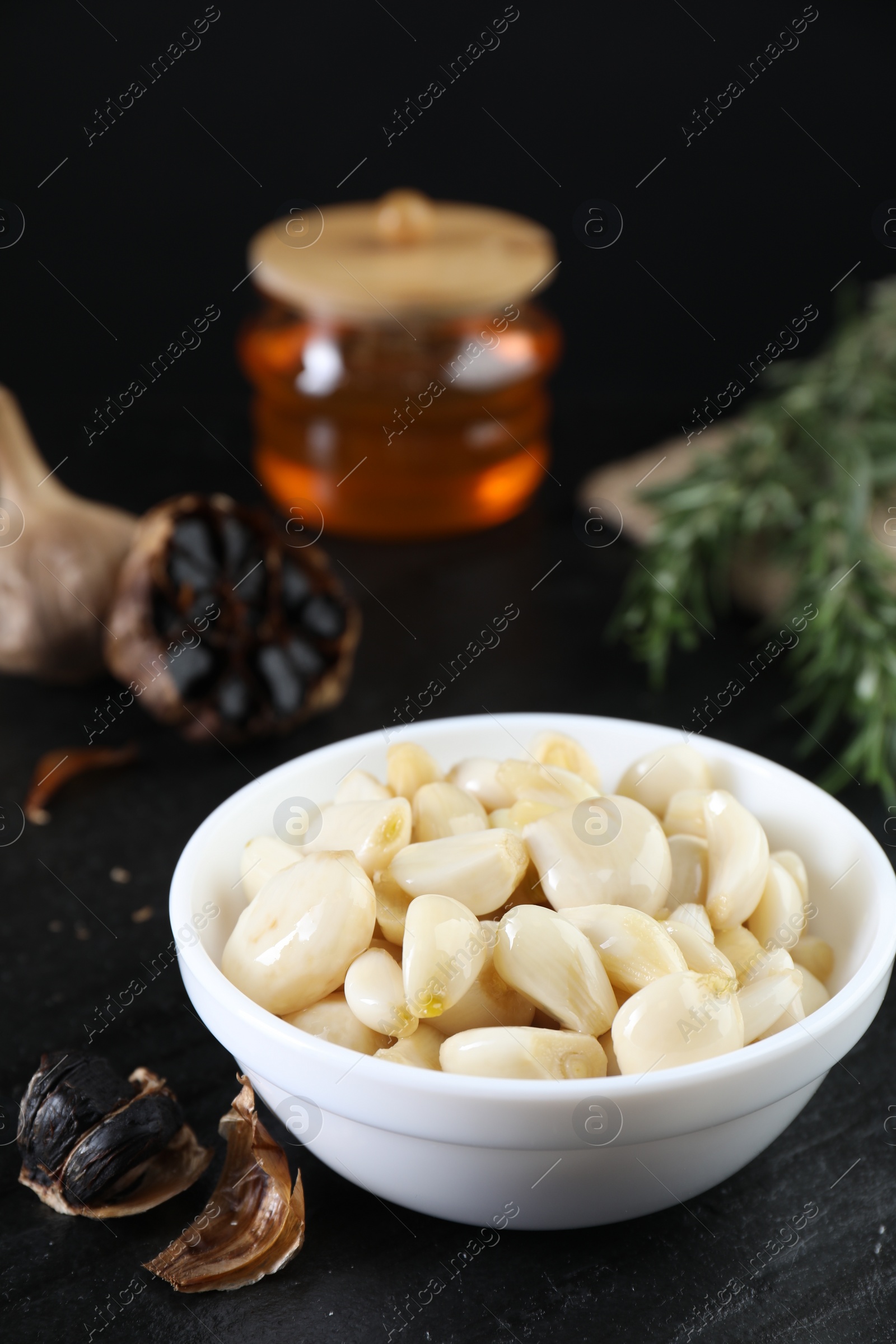 Photo of Fresh and fermented black garlic on table