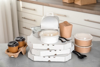 Various takeout containers on table in kitchen. Food delivery service