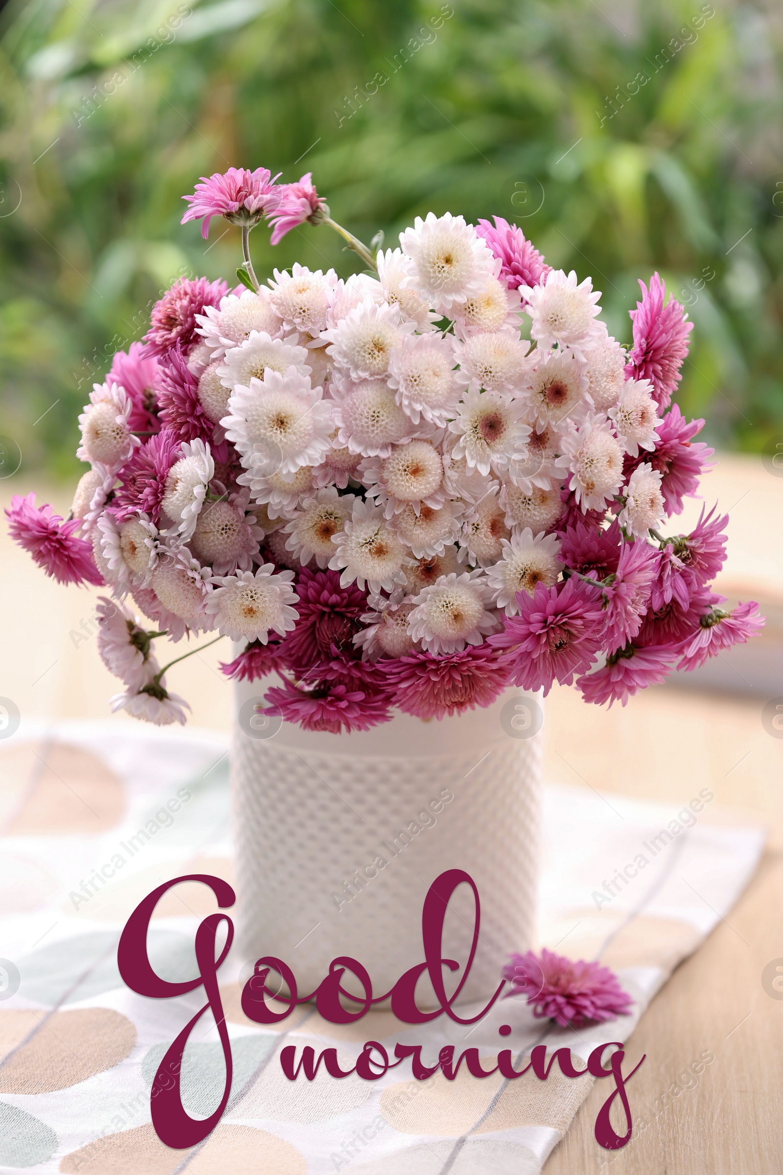 Image of Good morning! Vase with beautiful bouquet, books and cloth on wooden table