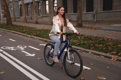 Photo of Happy beautiful woman with bicycle on lane in city