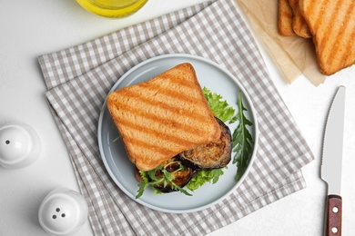 Photo of Delicious eggplant sandwich served on white table, flat lay