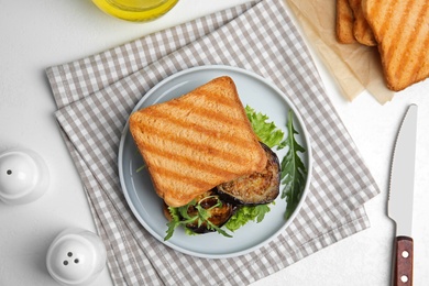 Delicious eggplant sandwich served on white table, flat lay