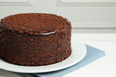 Photo of Delicious chocolate truffle cake on white table