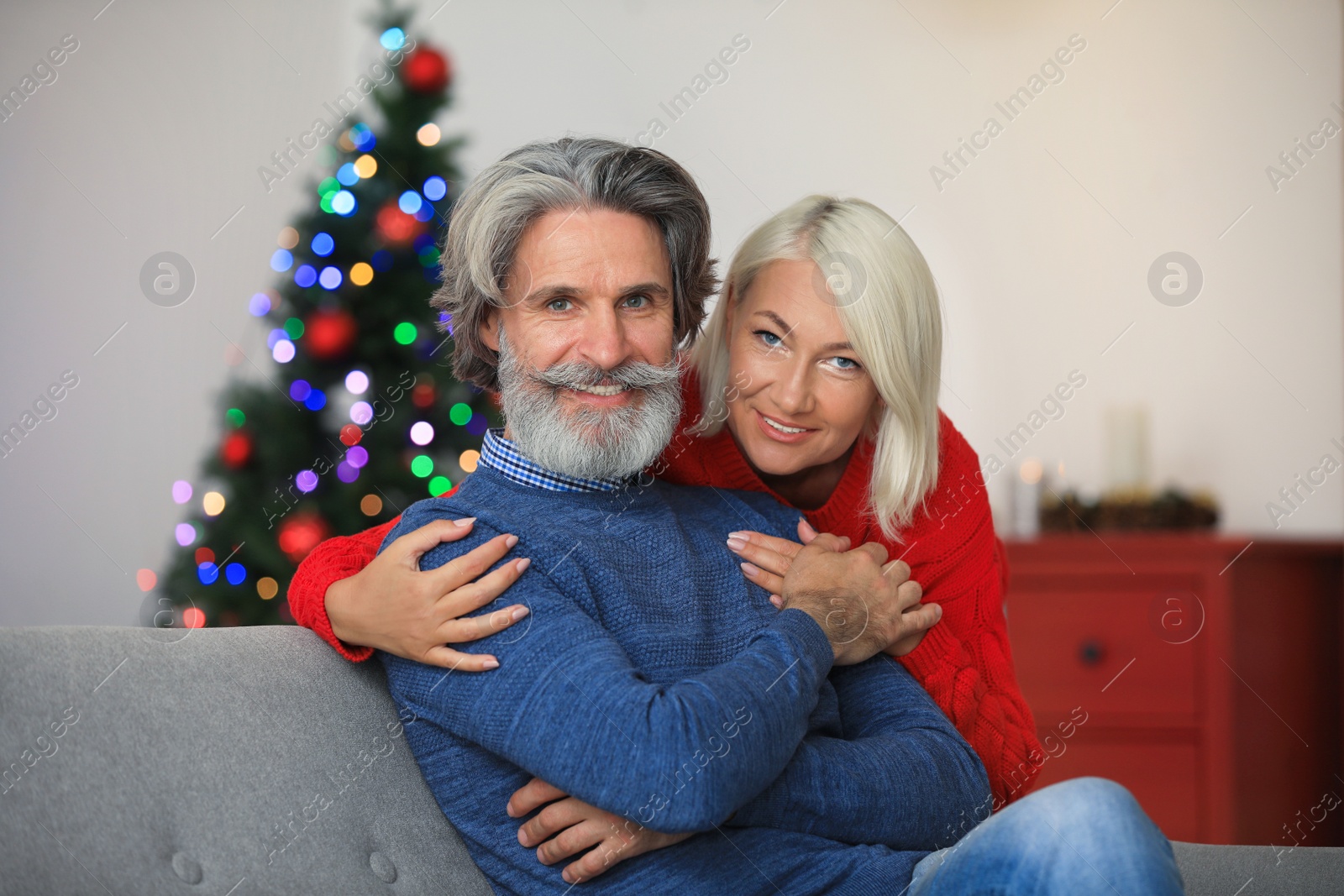 Photo of Happy mature couple celebrating Christmas at home