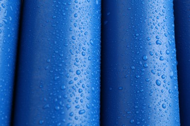 Energy drinks in wet cans as background, closeup