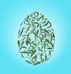 Image of Easter egg shape made of leaves on light blue background, flat lay 