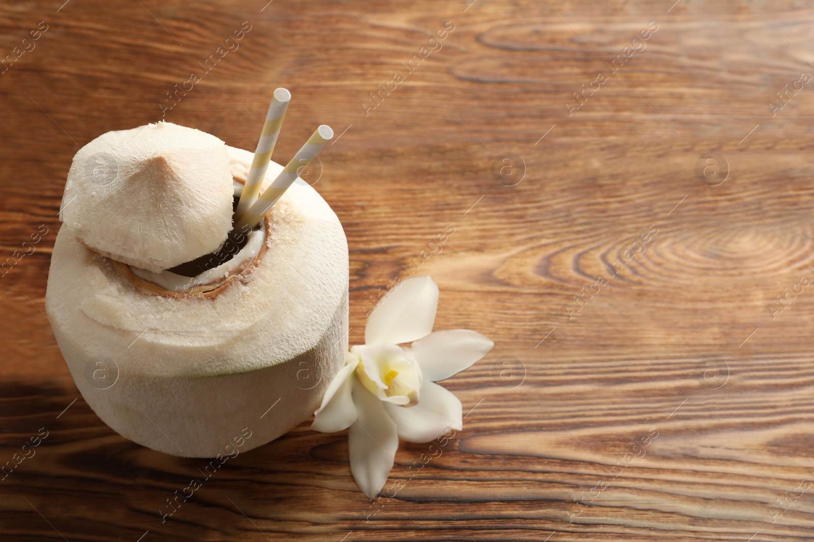 Photo of Fresh coconut drink in nut on wooden background