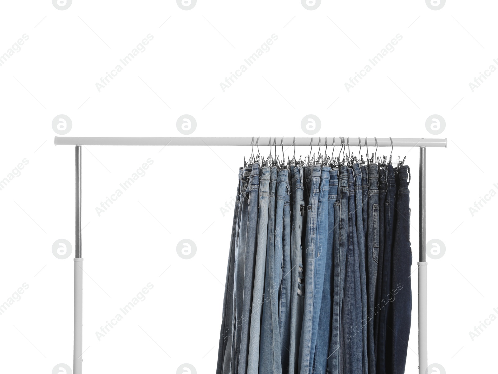 Photo of Rack with different jeans isolated on white