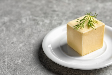 Photo of Plate with fresh butter on table, closeup. Space for text