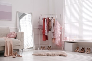 Photo of Modern dressing room interior with clothing rack and mirror