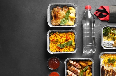 Photo of Lunchboxes on grey table, flat lay. Healthy food delivery