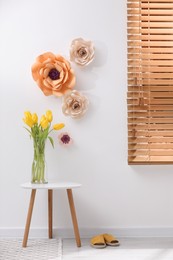 Stylish room interior with floral decor and yellow tulips