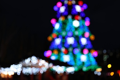 Photo of Beautiful decorated Christmas tree outdoors. Bokeh effect