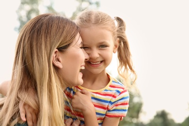 Woman with her child outdoors. Happy family