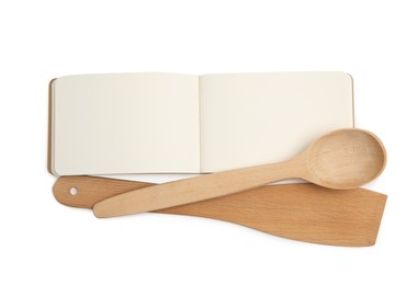 Photo of Blank recipe book and wooden utensils on white background, top view. Space for text