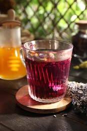 Aromatic herbal tea and dry lavender on wooden table