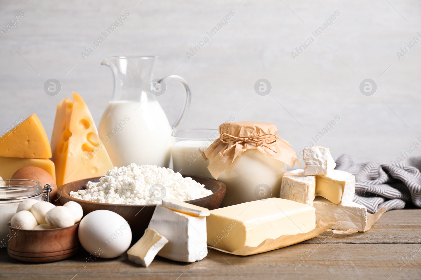 Photo of Different delicious dairy products on wooden table