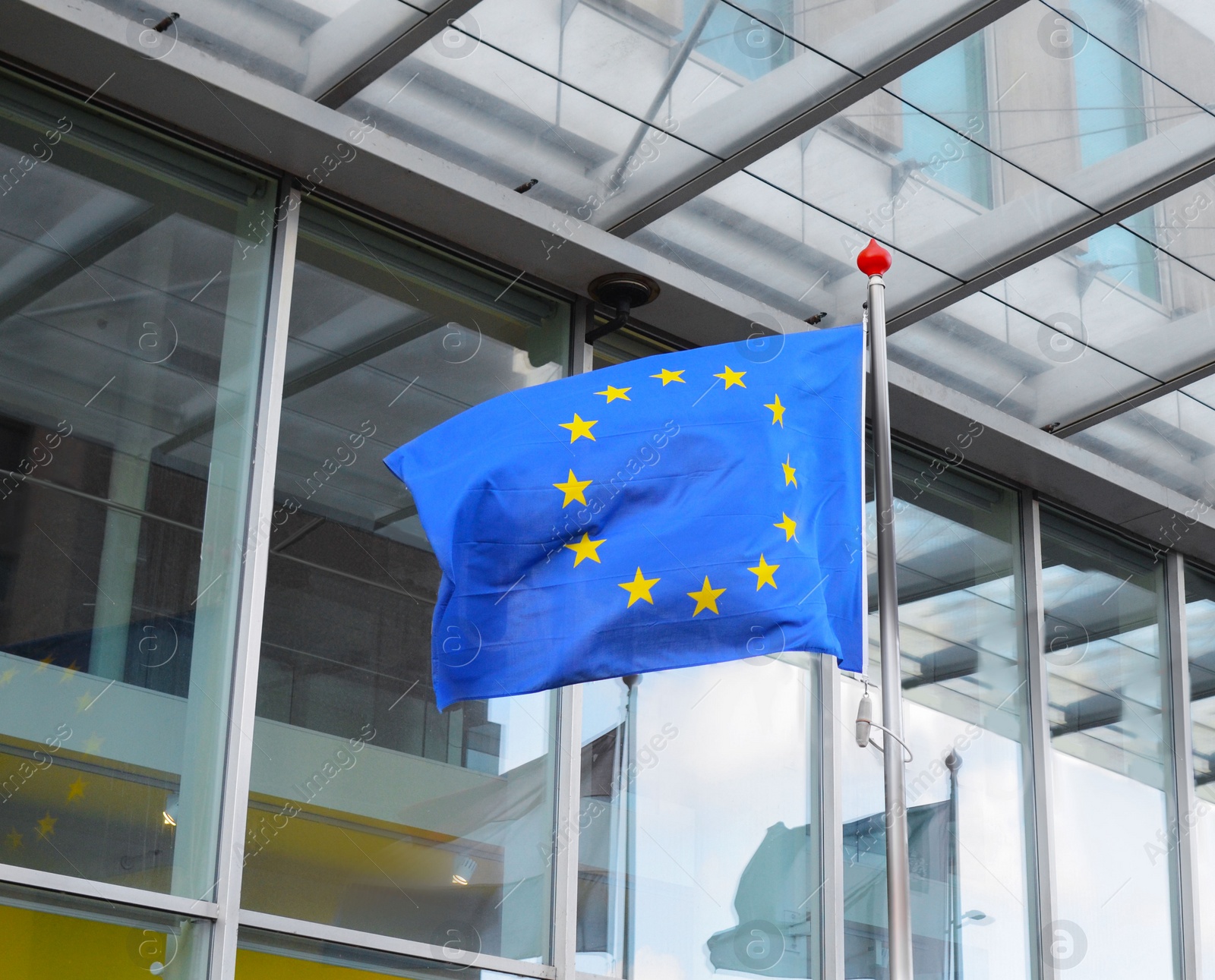 Photo of Flags of Netherlands and European Union near building on sunny day