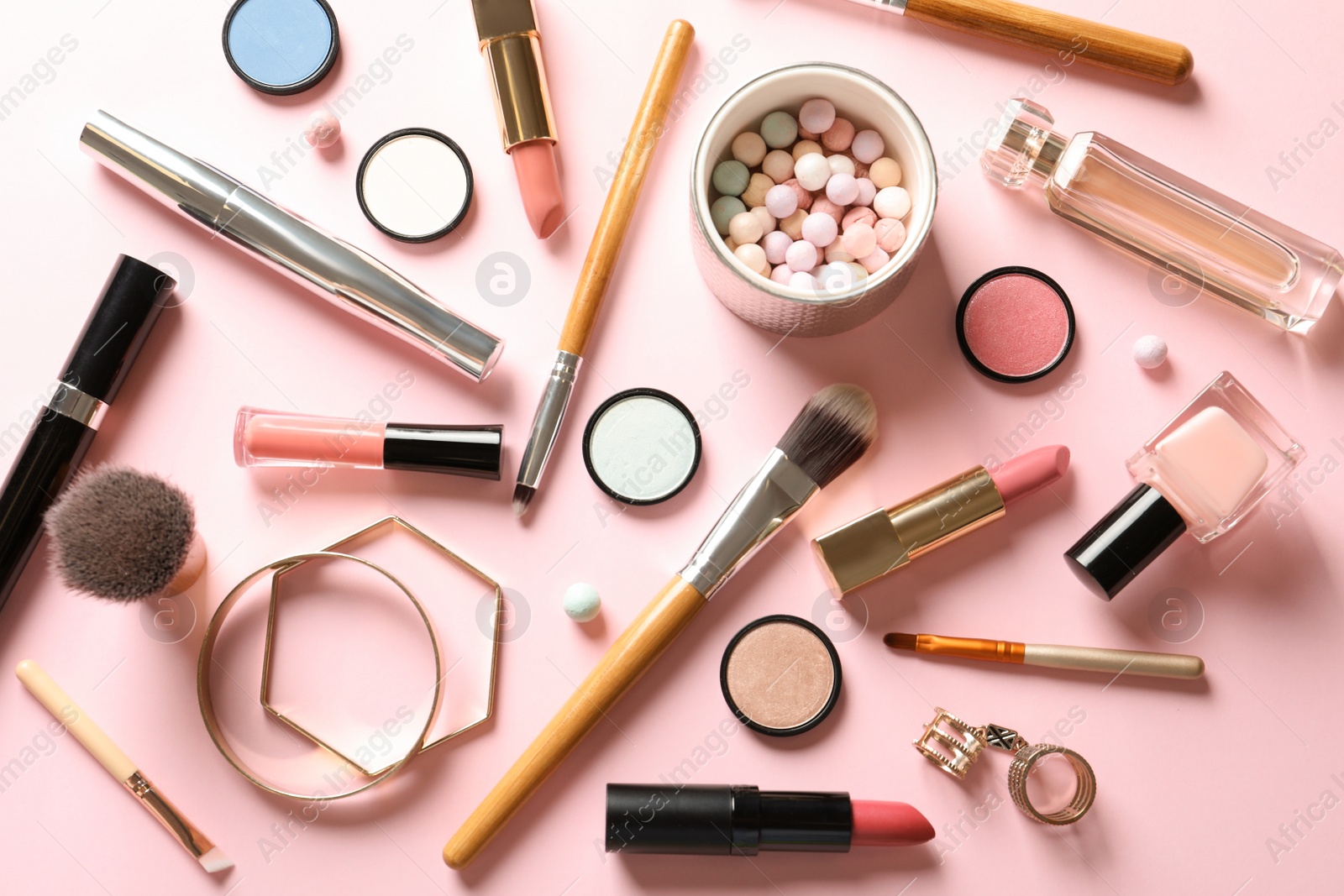 Photo of Flat lay composition with products for decorative makeup on pastel pink background