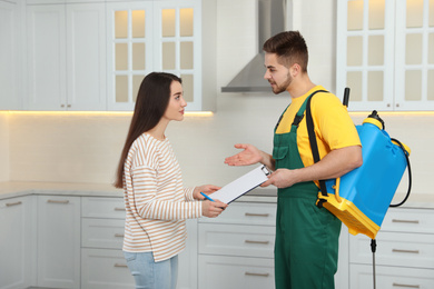 Woman signing documents at home. Pest control service