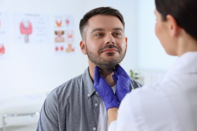 Photo of Endocrinologist examining thyroid gland of patient at hospital