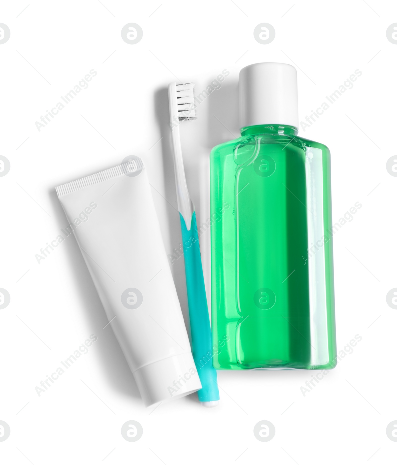 Photo of Fresh mouthwash in bottle, toothpaste and toothbrush isolated on white, top view
