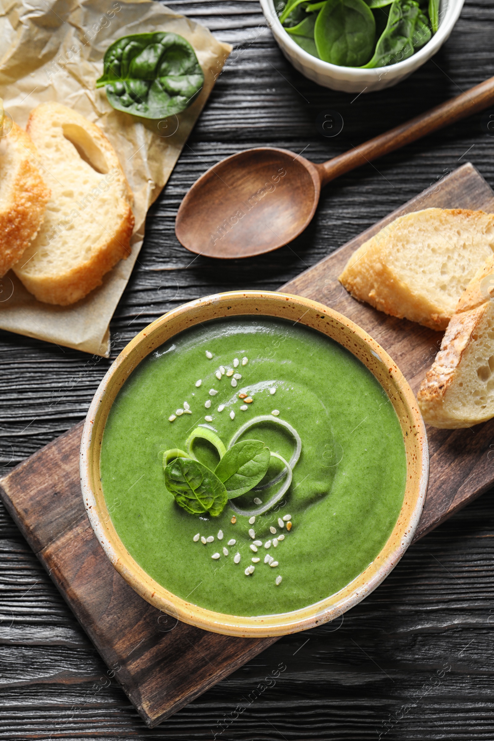 Photo of Fresh vegetable detox soup made of spinach served on table, top view