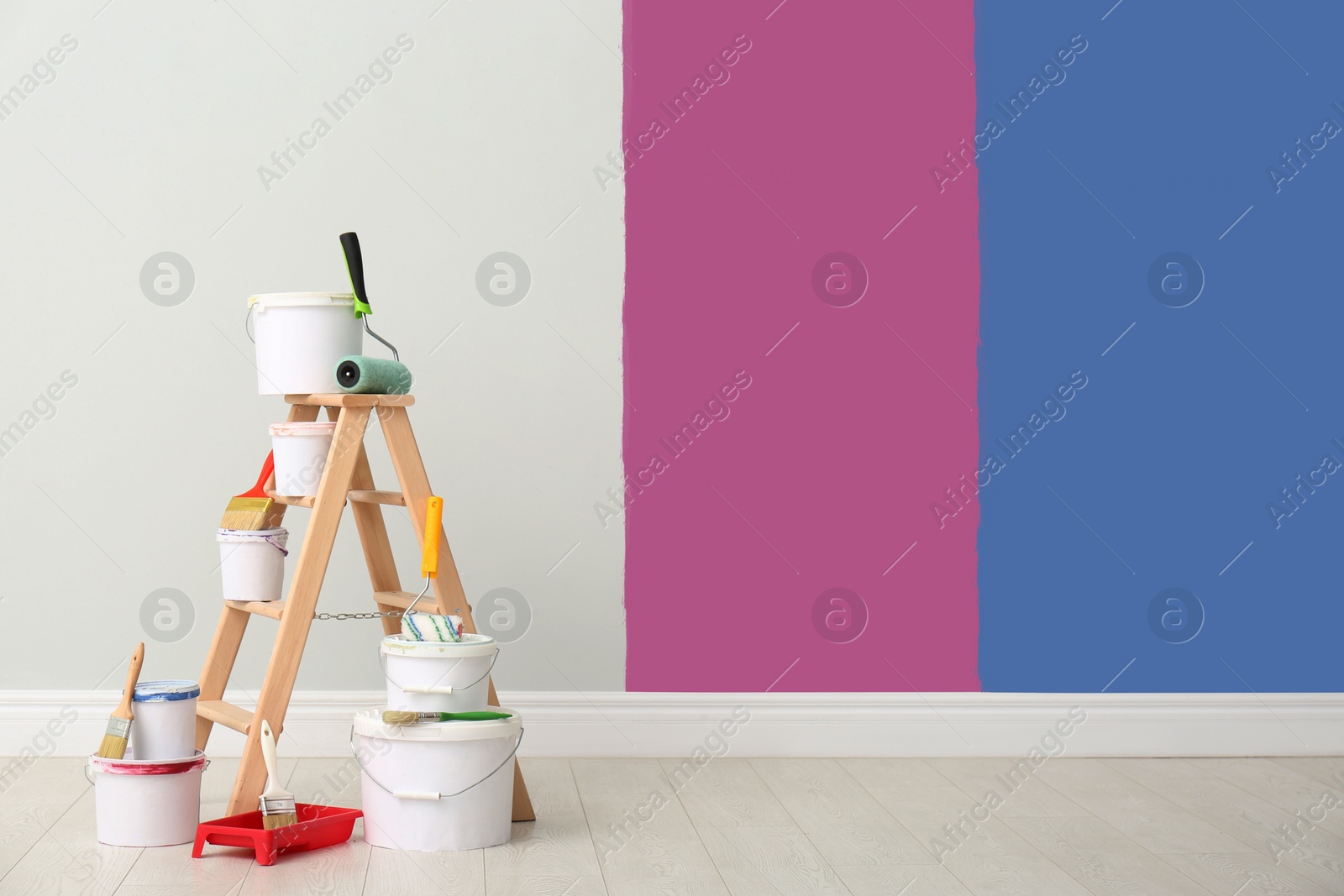 Image of Decorator's kit of tools and paints near wall indoors